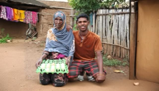 Joyful Ethiopian woman standing beside her children after receiving essential aid from Islamic Relief Ethiopia.